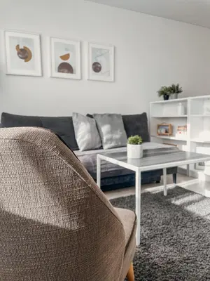 a living room with a couch and a table at Marijampole Apartment with FREE Parking in Marijampolė