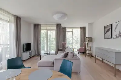 a living room with a couch and a table at SoulHouse apartments in Druskininkai