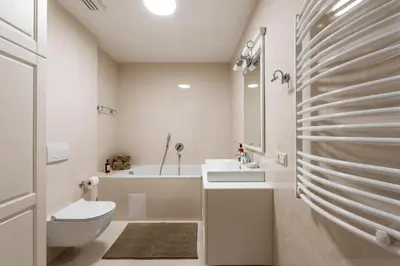 a white bathroom with a toilet and a sink at SoulHouse apartments in Druskininkai