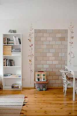 a living room with a table and a brick wall at Villa Kurorto Namas in Druskininkai