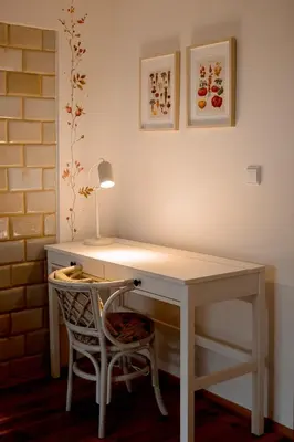 a white desk with a chair and a lamp at Villa Kurorto Namas in Druskininkai