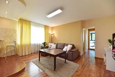 a living room with a couch and a table at Oksanos apartamentai Druskininkuose atskiras įėjimas 1 aukštas in Druskininkai