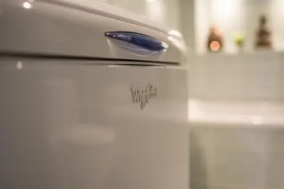 a white refrigerator with a sticker on the door at Oksanos apartamentai Druskininkuose atskiras įėjimas 1 aukštas in Druskininkai