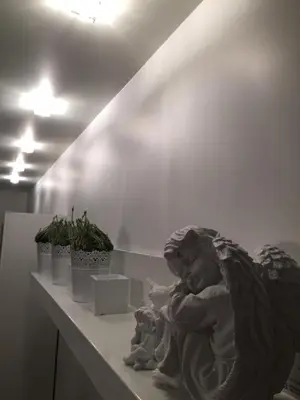 a statue of a baby sitting on a shelf at Angel's Dream Apartment in Anykščiai