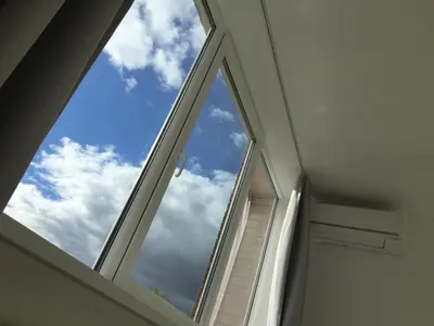 an arched window in a room with the sky at Angel's Dream Apartment in Anykščiai