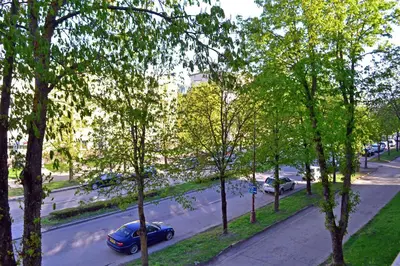 a view of a city street with cars on the road at Draugystės Apartment in Šiauliai