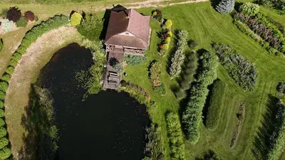 an aerial view of a house next to a lake at Mikalojiškis in Inturkė