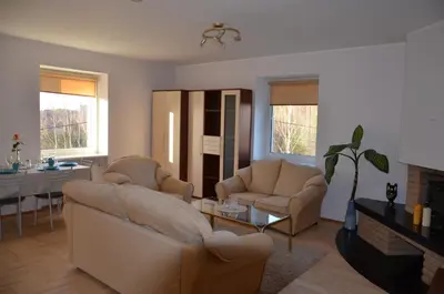 a living room with two couches and a table at Apartments with outdoor SPA jacuzzi and sauna in Vilnius