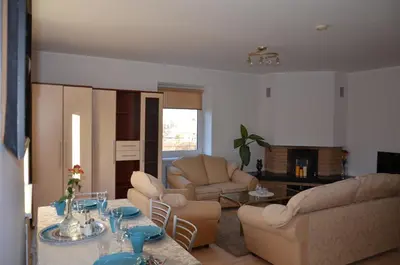 a living room with a couch and chairs and a table at Apartments with outdoor SPA jacuzzi and sauna in Vilnius