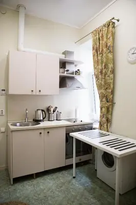 a small kitchen with a sink and a table at Centro apartment near Gedimas Avenue in Vilnius