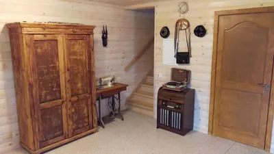 a room with a wooden cabinet and a small table at Arturas Guest House in Vilnius