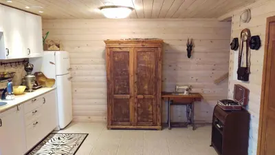 a kitchen with a wooden cabinet and a table at Arturas Guest House in Vilnius