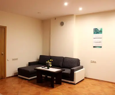 a waiting room with a couch and a table at Vidų Guest House in Utena