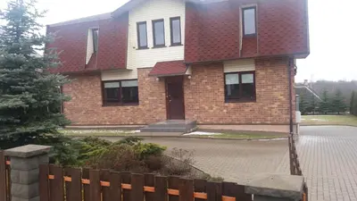 a brick house with a red roof at Vidų Guest House in Utena