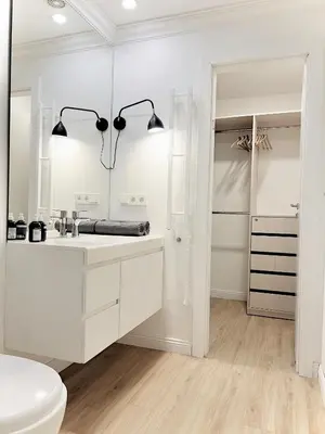 a white bathroom with a sink and a mirror at Tomy Old Town Apartments in Vilnius