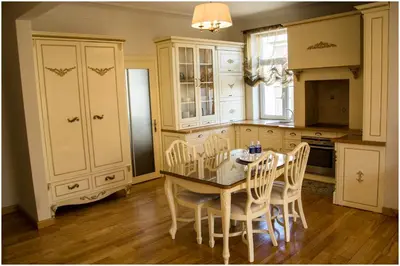 a kitchen with a table and chairs in a room at Broadway apartament in Šiauliai