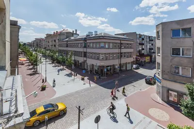 an overhead view of a city street with a yellow car at Broadway apartament in Šiauliai