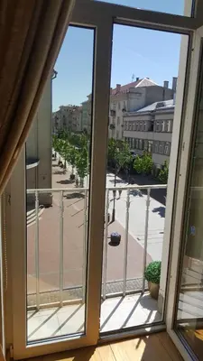 an open window with a view of a street at Broadway apartament in Šiauliai