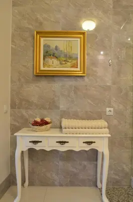 a white table in a room with a picture on the wall at Broadway apartament in Šiauliai
