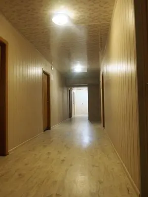 an empty hallway in an office building with a light on the ceiling at Hostelis Laurita in Kaunas