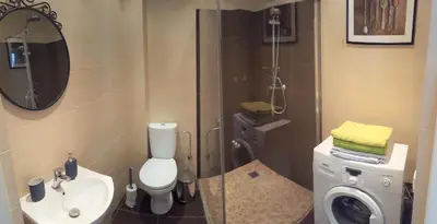 a bathroom with a shower with a toilet and a sink at Igo Apartment Townhall in Vilnius