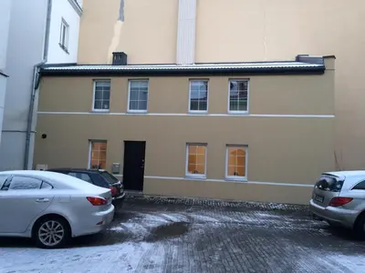 a building with cars parked in front of it at Igo Apartment Townhall in Vilnius