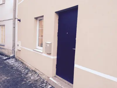 a black door on the side of a building at Igo Apartment Townhall in Vilnius