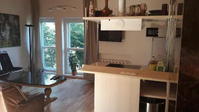a kitchen with a counter top and a table at Vilnius Luxury Apartment 2 in Vilnius