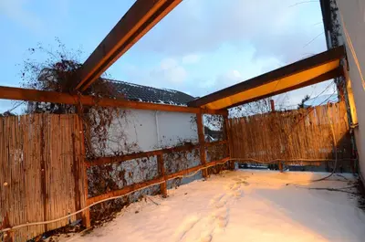 an outside view of a fence with snow on the ground at Vilnius Luxury Apartment 2 in Vilnius