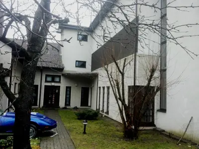 a house with a blue car parked in front of it at Vilnius Luxury Apartment 2 in Vilnius