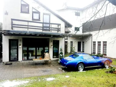 a blue car parked in front of a house at Vilnius Luxury Apartment 2 in Vilnius