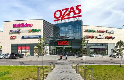 a building with a mas sign on top of it at Apartments Ozo Park in Vilnius