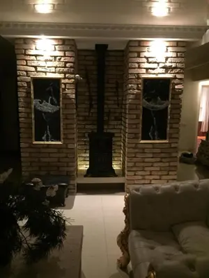 a living room with a brick fireplace and a couch at Vilnius Luxury Apartment 3 in Vilnius