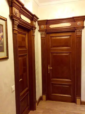 a large wooden door in a room with at Luxury Pilies Avenue Apartment in Vilnius