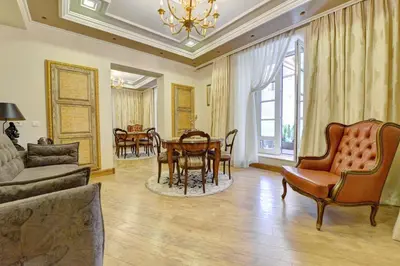 a living room with a couch and a table and chairs at Luxury Pilies Avenue Apartment in Vilnius