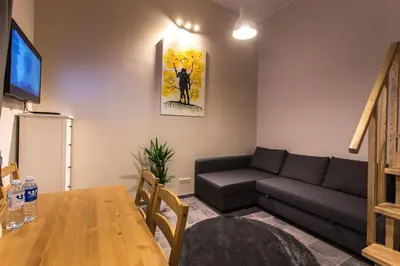 a living room with a couch and a table at Inga Vacation House in Druskininkai