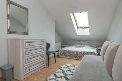 a bedroom with a bed and a dresser and a mirror at Vilnius Old Town Happiness in Vilnius