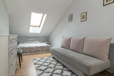 a living room with a couch and a bed at Vilnius Old Town Happiness in Vilnius