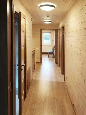 an empty hallway with wooden walls and a hallway with a hallwayngthngthngthngth at Aitvaras in Anykščiai