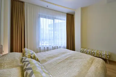 a bedroom with a bed and a large window at 555 SoleSun in Druskininkai