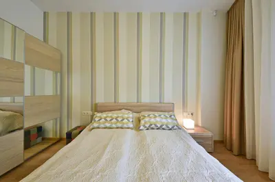 a bedroom with a bed with two pillows on it at 555 SoleSun in Druskininkai