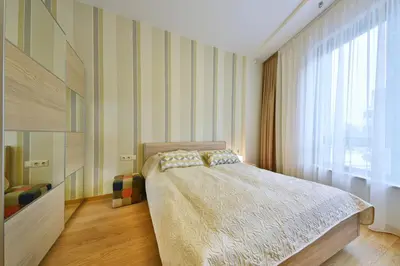 a bedroom with a bed and a large window at 555 SoleSun in Druskininkai