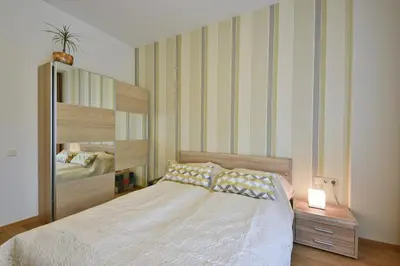 a bedroom with a large bed and a mirror at 555 SoleSun in Druskininkai