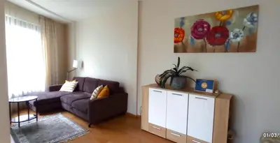 a living room with a couch and a table at 555 SoleSun in Druskininkai