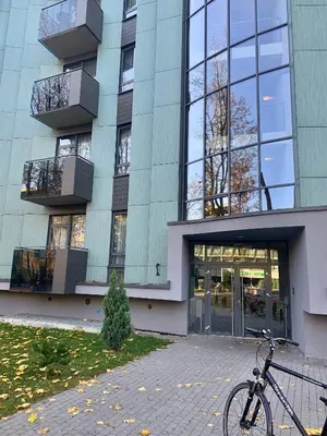 a bike parked in front of a building at 555 SoleSun in Druskininkai