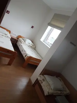 two bunk beds in a room with a window at Domeikavos vila in Ražiai