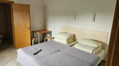 a bedroom with a bed with two pillows on it at Domeikavos vila in Ražiai