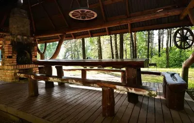 a picnic table on a deck in a cabin at Kaimo Turizmo Sodyba Šniūrai in Mindūnai