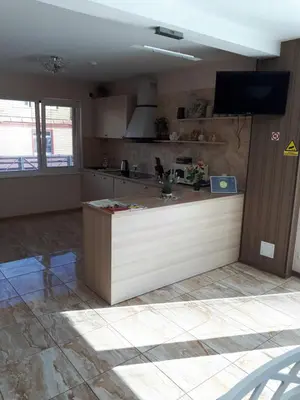 a kitchen with a counter top in a room at Juro Guest House in Šiauliai