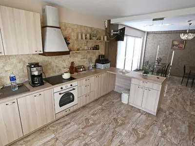 a kitchen with a sink and a stove top oven at Juro Guest House in Šiauliai